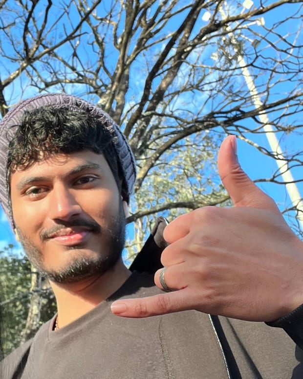 Revanth Darshan D R outdoors on a clear winter day, wearing a knit beanie.